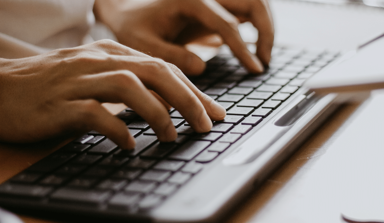 A computer user using a keyboard and mouse.