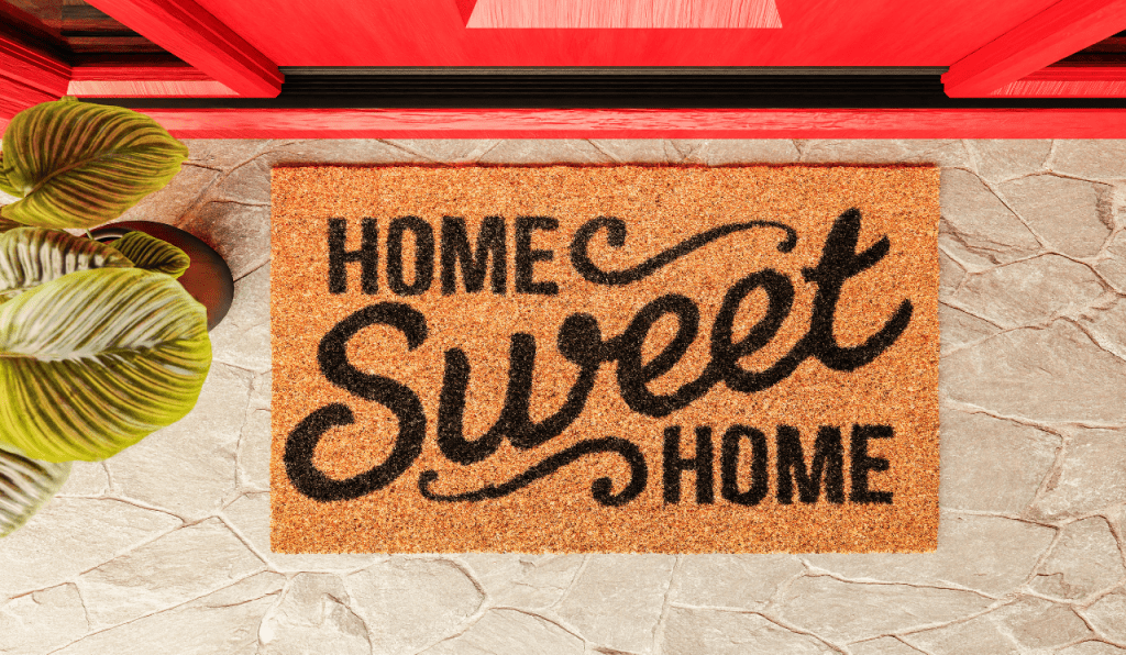 A front door mat with the words home sweet home printed onto it.