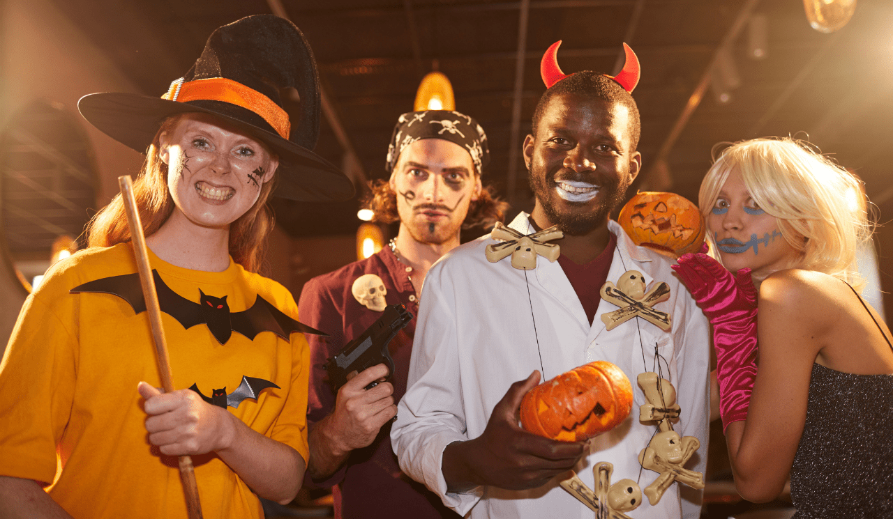 A group of four friends standing next to each other, each wearing their own homemade Halloween outfir.